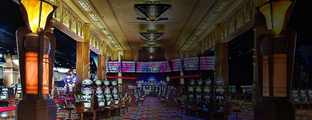 Inside casino with rows of slot machines.